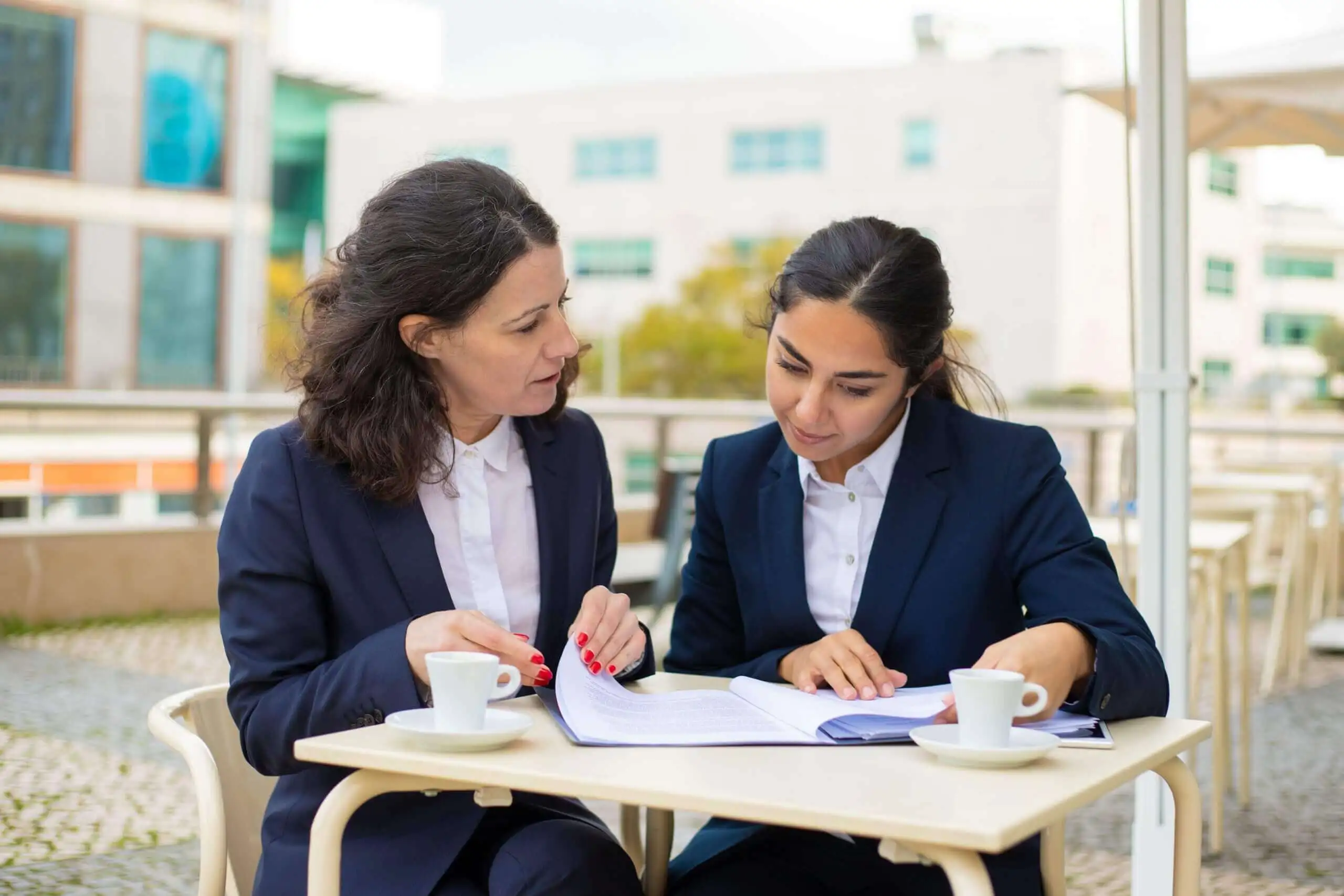 businesswomen-working-with-papers-outdoor-cafe-scaled (1) (1) Digital Nest, Digital Nest School of Business